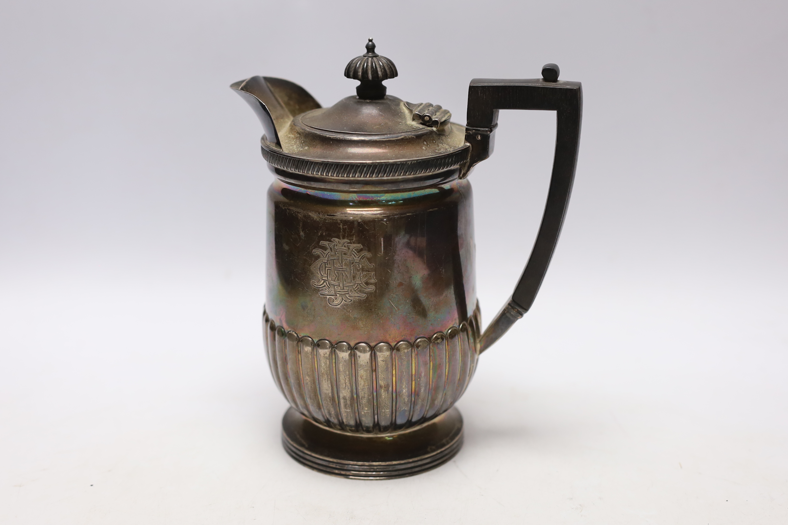 A late Victorian demi-fluted silver hot water jug, Mappin & Webb, Sheffield, 1897, gross weight 17.6oz.